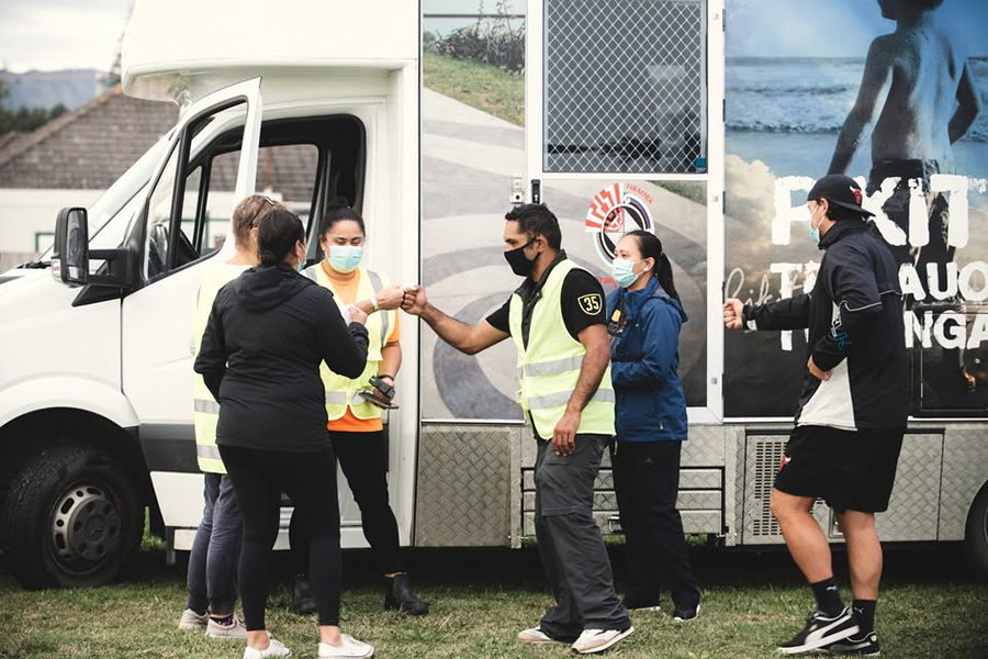 people standing in front of a van 