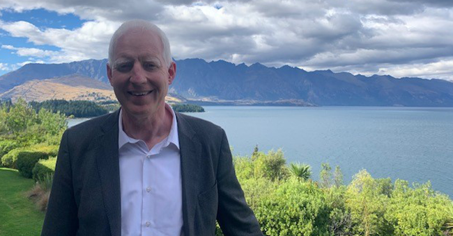 A man standing in front of nice scenery 