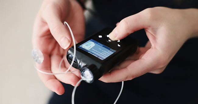 woman holding insulin pump