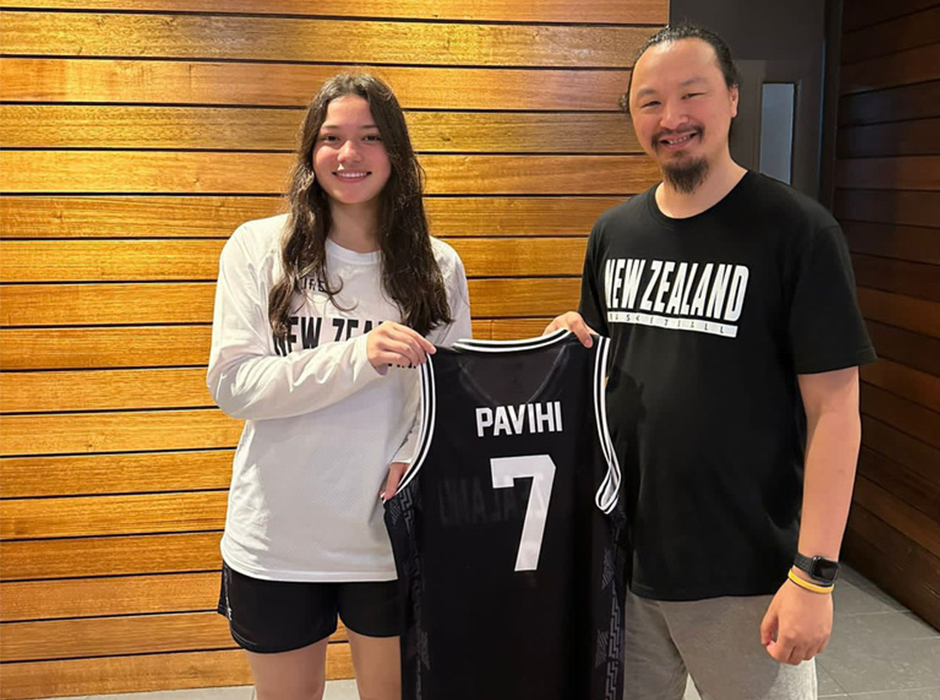 Tia Pavihi’s Junior Tall Ferns basketball coach Josh Thompson presents her with her singlet in Papua New Guinea last year ahead of the Oceania Cup. 