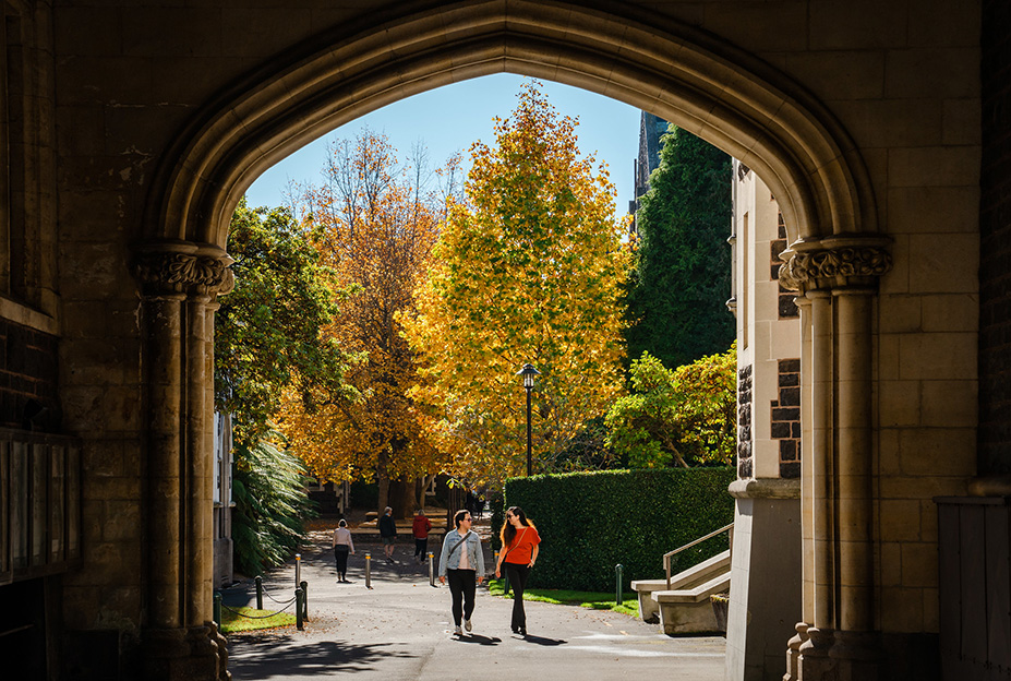 Students on campus walking through gate