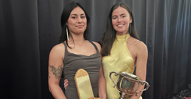 two women holding prizes 