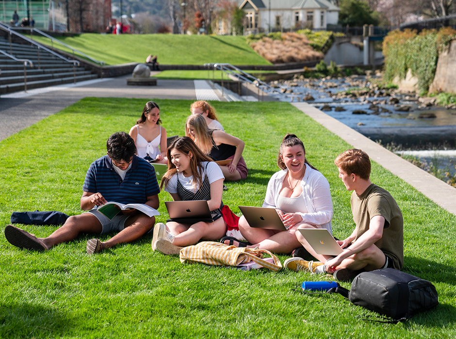 Students using laptops outside