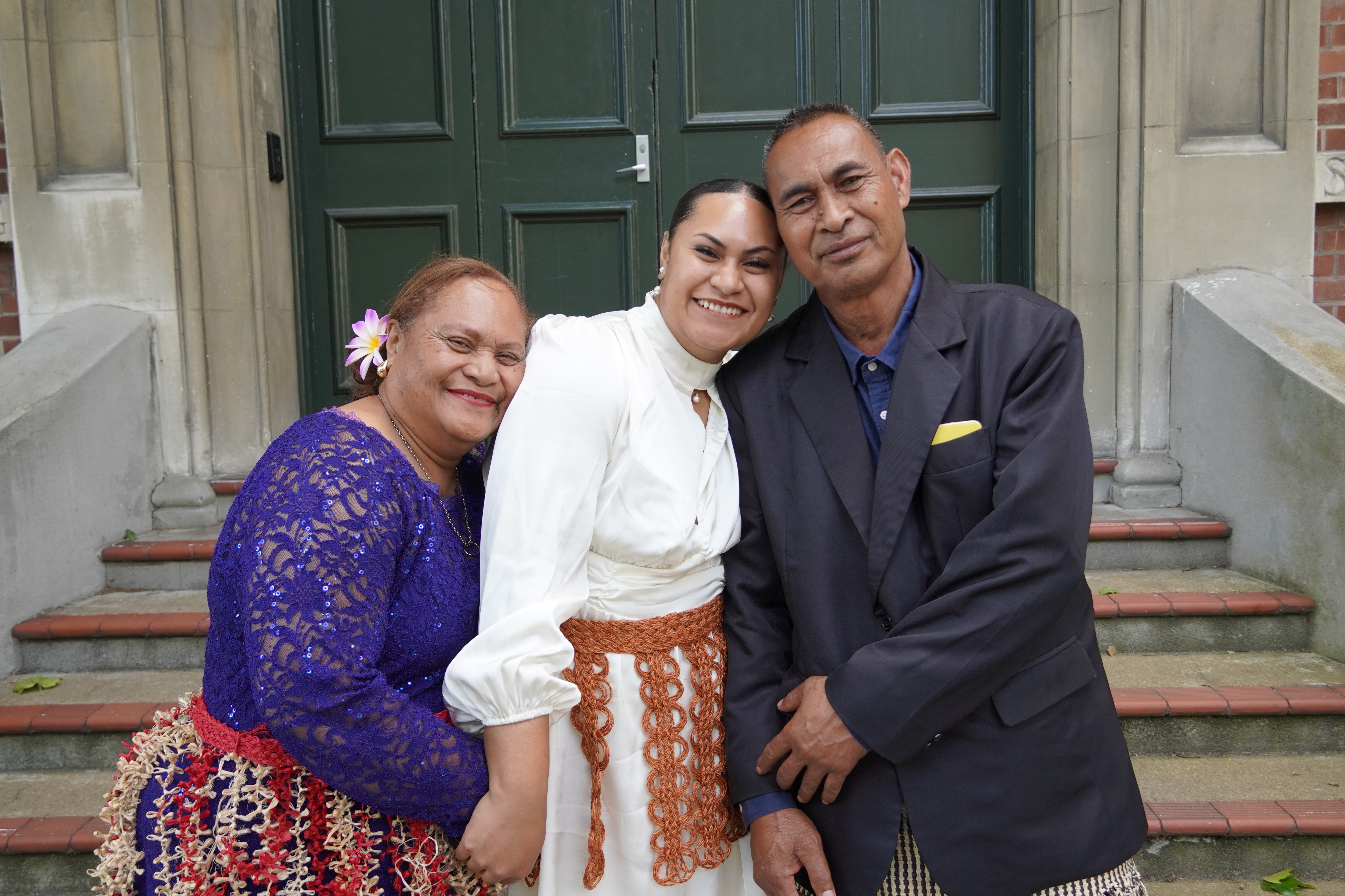 Melenia Kaitaeifo (middle) pictured with her parents by her side who are all smiles celebrating their daughter’s achievement at medical school. 