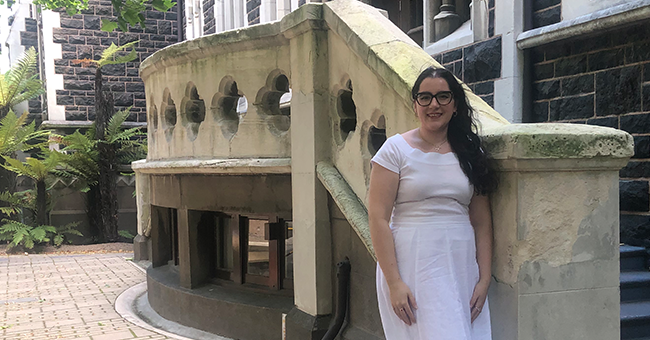 A woman standing next to some stairs 