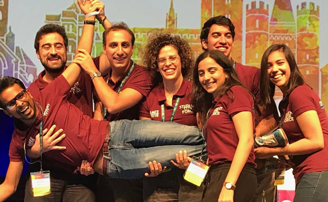 Roshit (held up by other medical students) at the AMEE Conference, after winning the Teaching Innovation Award. 