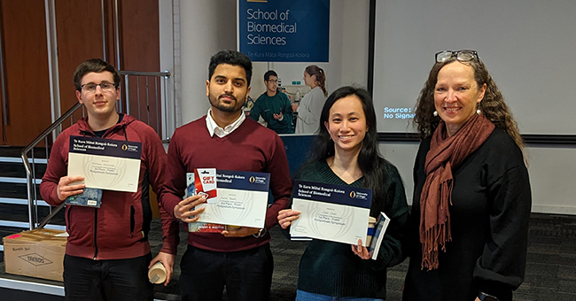 Posters presentation place getters from left, Mathew Anscombe (Physiology), Kartik Rawat (Microbiology & Immunology) and Joan Chan (Physiology) with BMS Dean Lisa Matisoo-Smith. 