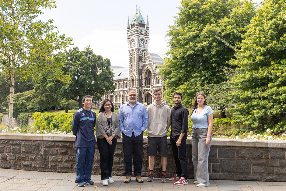 Husain Lab group photo with Clocktower in background.