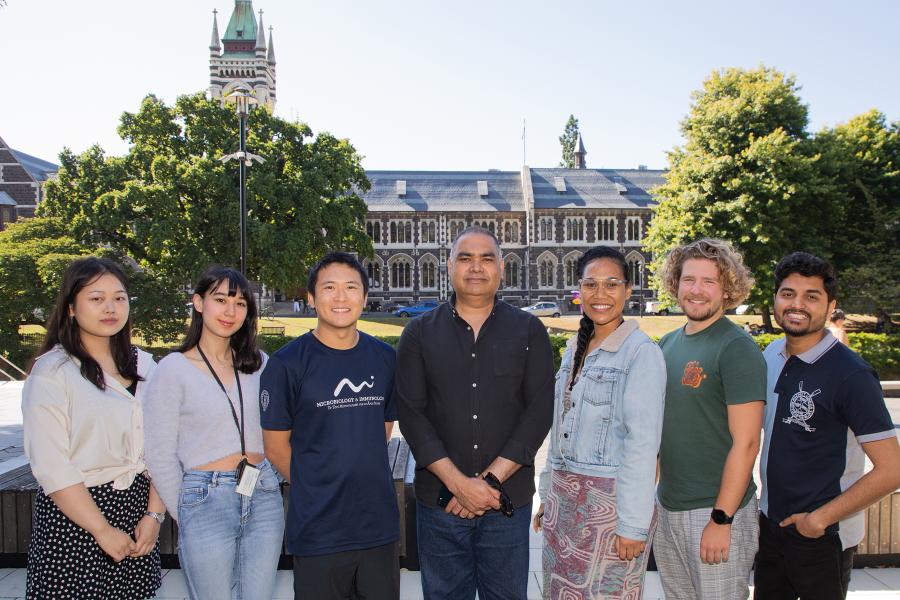 Husain Lab group photo with Clocktower in background.