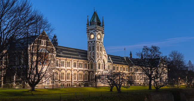 University of Otago Clocktower building viewed from across the Leith river at night