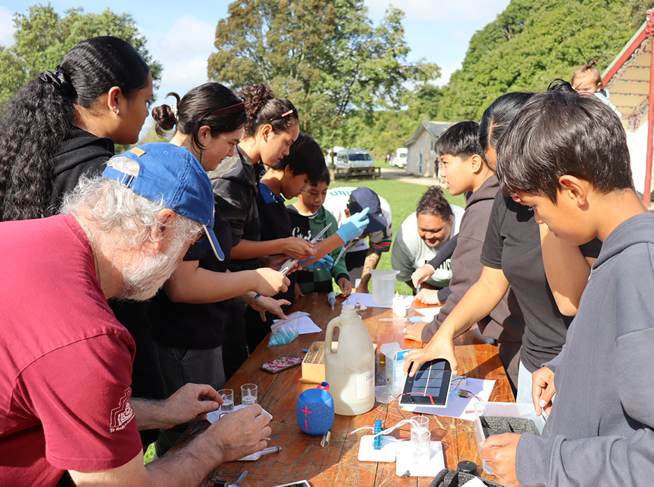 a group of people working together around a table