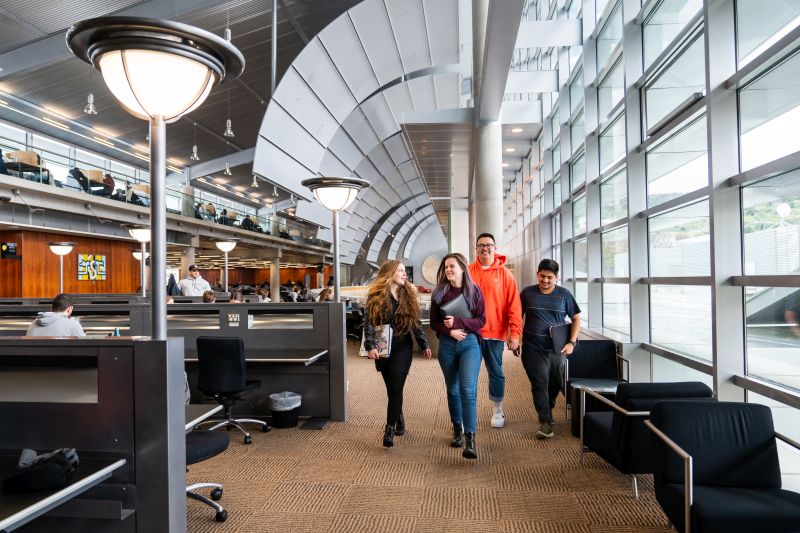 Group of students walking through the library