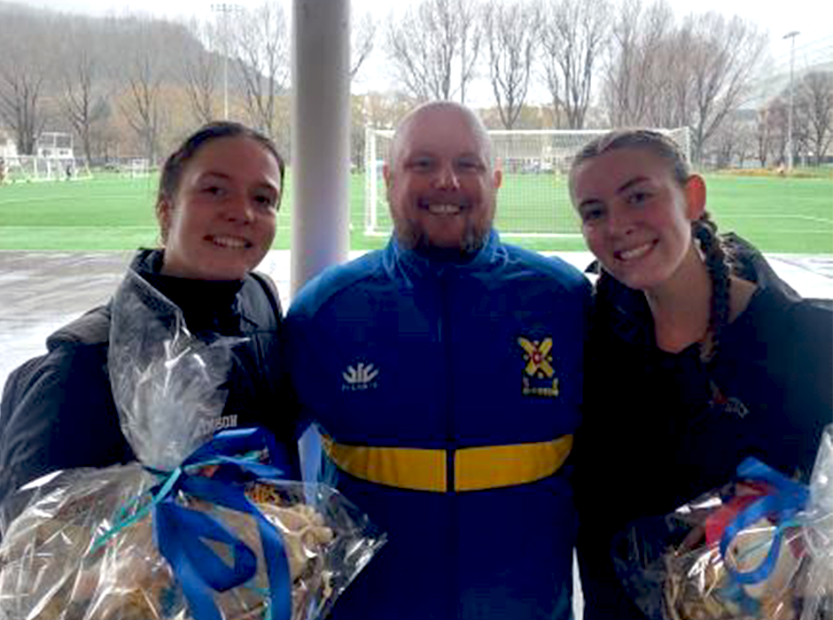 United States students Emily Dunkel, left, and Giada Bambi, who came to Otago in semester one as part of the Study Abroad programme, are farewelled by their Otago University Association Football Club coach Hamish Philip.
