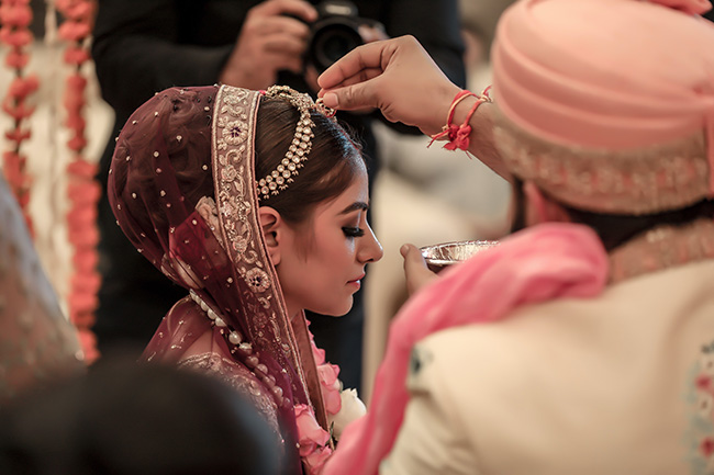 A bride undergoing religious ritual before wedding ceremony.