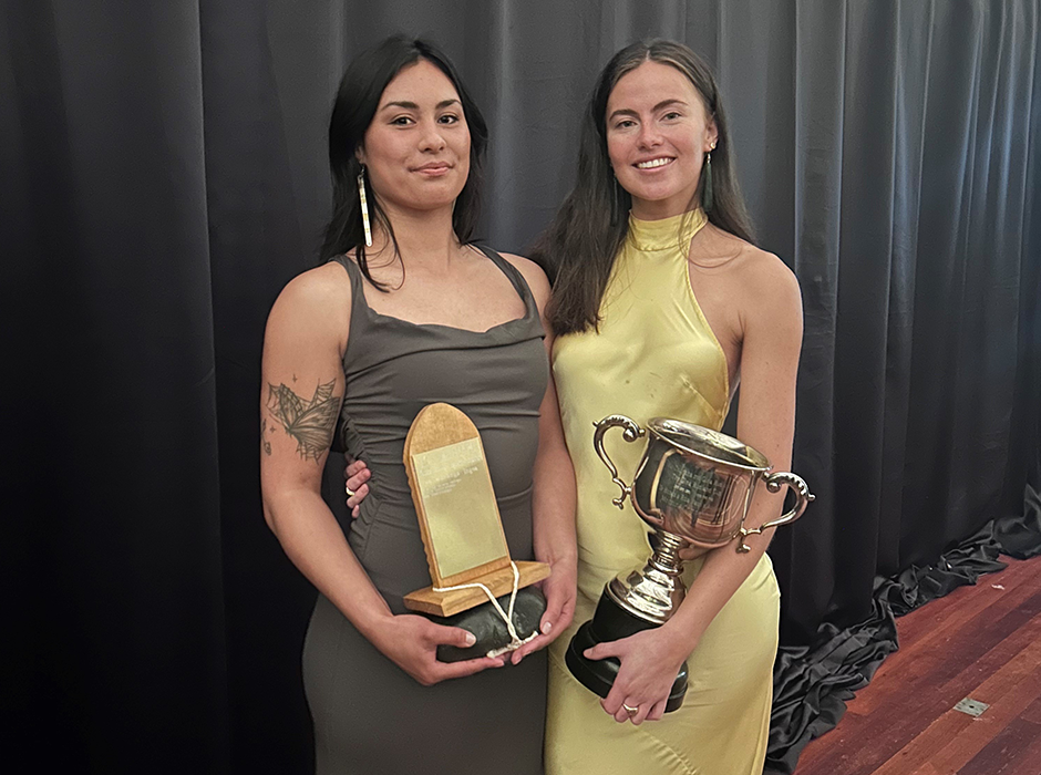 two women holding prizes 