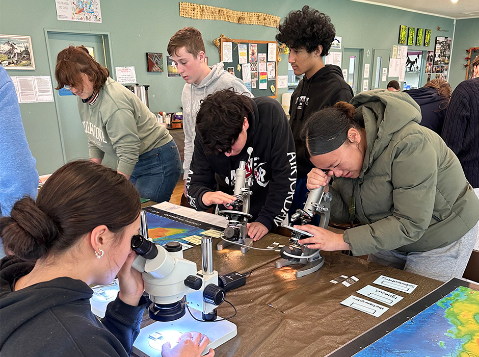 Young people using microscopes