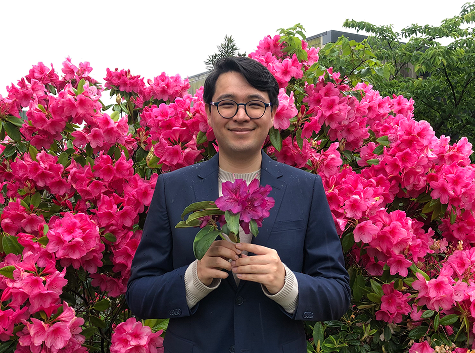 A man holding a rhododendron 