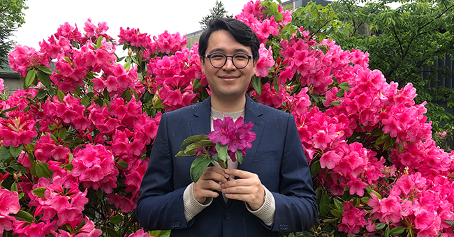 A man holding a rhododendron 