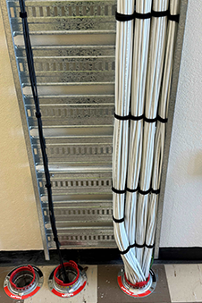 The big and small of it … Otago’s new glass fibre optic IT network cabling (left, coloured black) in the Science III building compared to the previous cabling (right), which was copper covered in white insulation. 