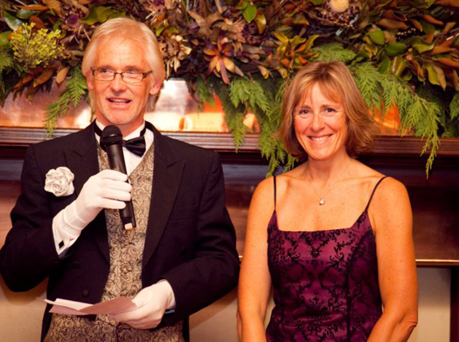 Two people standing in front of festive decorations