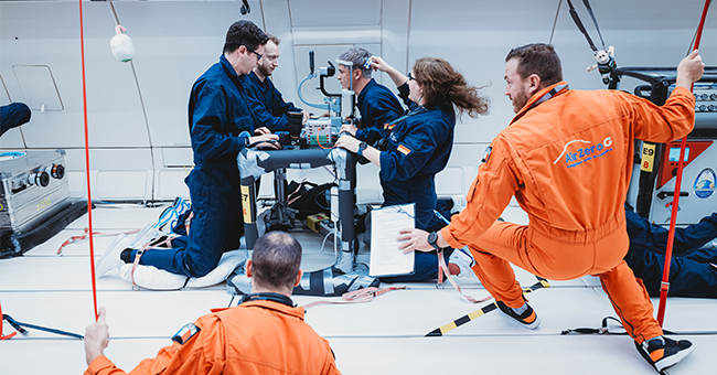 Dr Francesc March, left, undertakes a tear film assessment in microgravity during a parabolic flight.