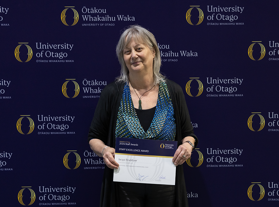 A woman holding an award