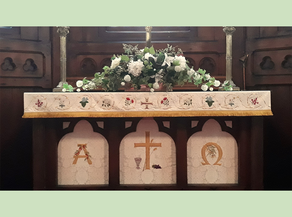 An altar with embroidered cloth hanging on it