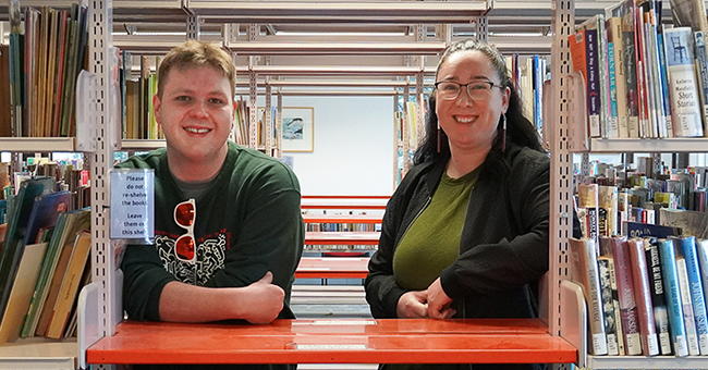 Otago tauira Jimmy Robinson and alumna Tāwini White in the Robertson Library