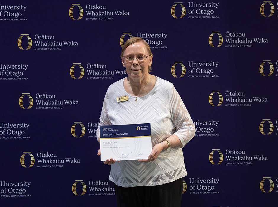 A woman holding an award