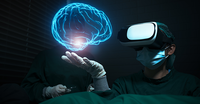 two people in medical scrubs, one wearing an virtual reality headset that has as virtual image of a neon blue brain hovering above their hand