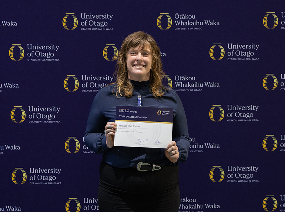 A woman holding an award