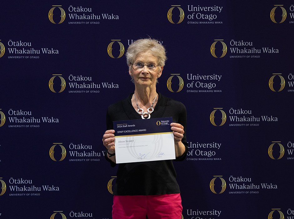 A woman holding an award