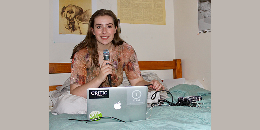 girl recording radio show in bed